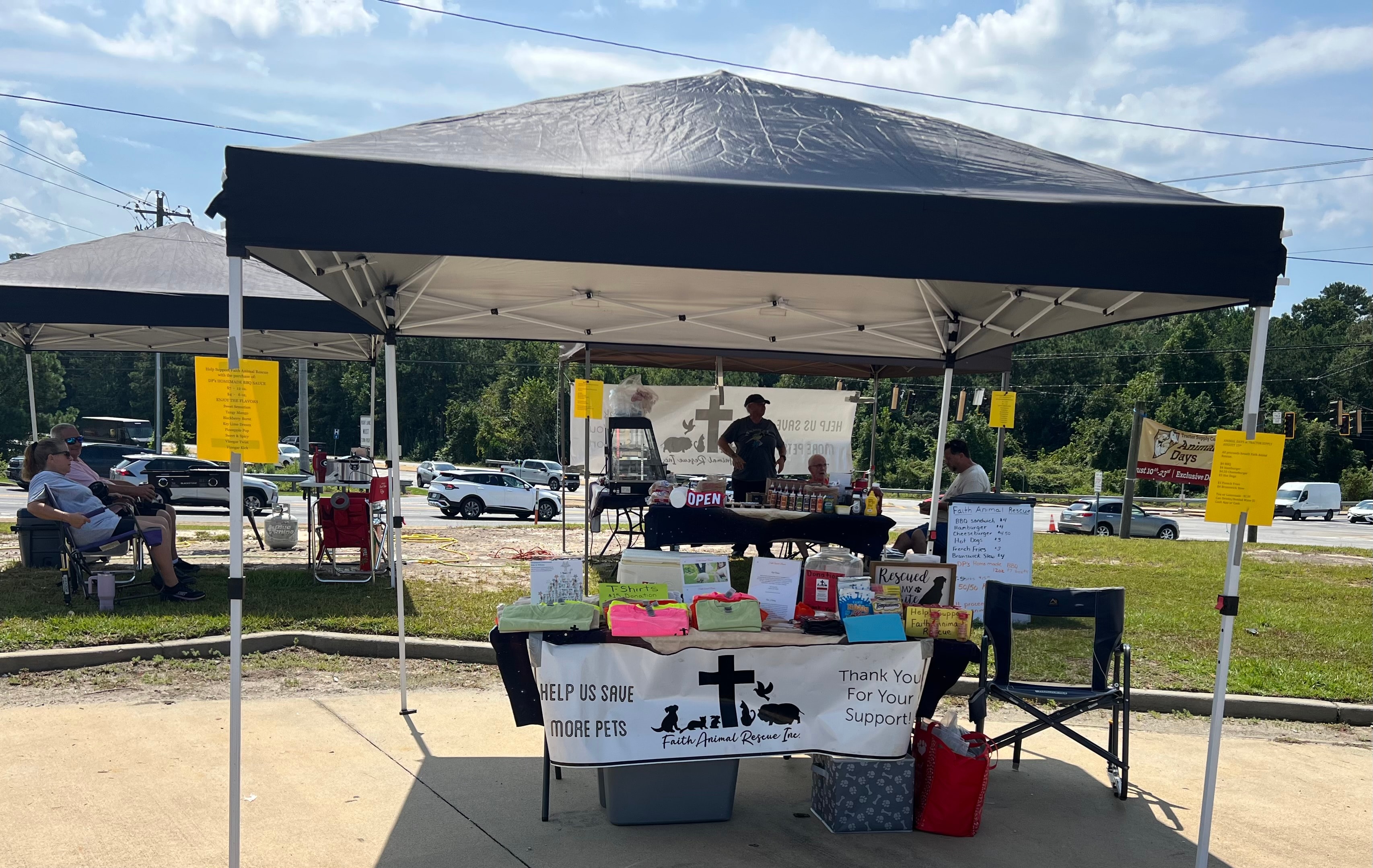 Faith Animal Rescue fundraiser tent setup with donation table and signage