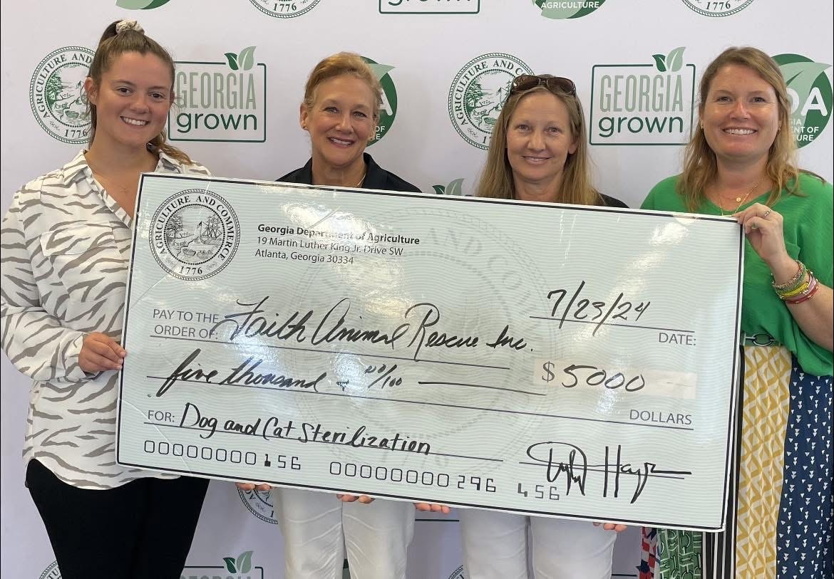 Faith Animal Rescue team holding $5,000 Georgia Department of Agriculture grant check for dog and cat sterilization